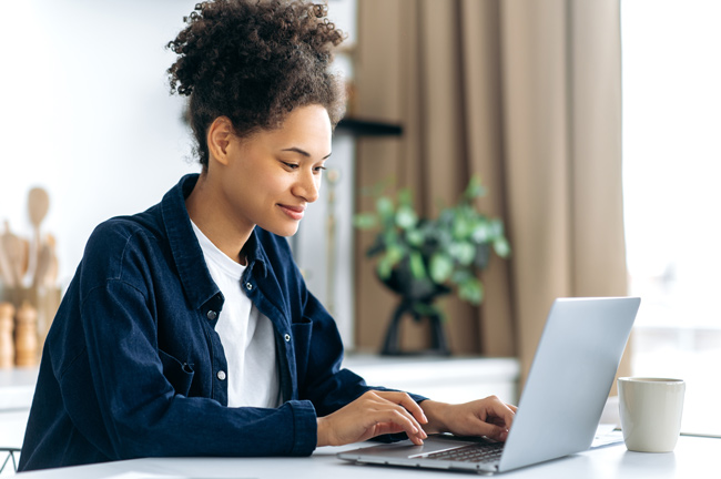 casual black woman at laptop shutterstock 2142798171 650x432