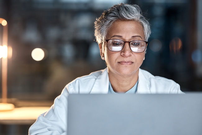 woman lab tech at laptop shutterstock 2254998251 650x434